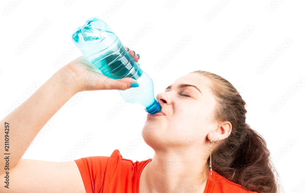 Young woman refreshing by drinking water from plastic bottle. Young woman refreshing by drinking water from plastic bottle.