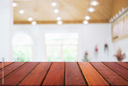 Empty wooden table and blurred background of abstract in front of coffee shop or restaurant for display of product or for montage © Freedomz