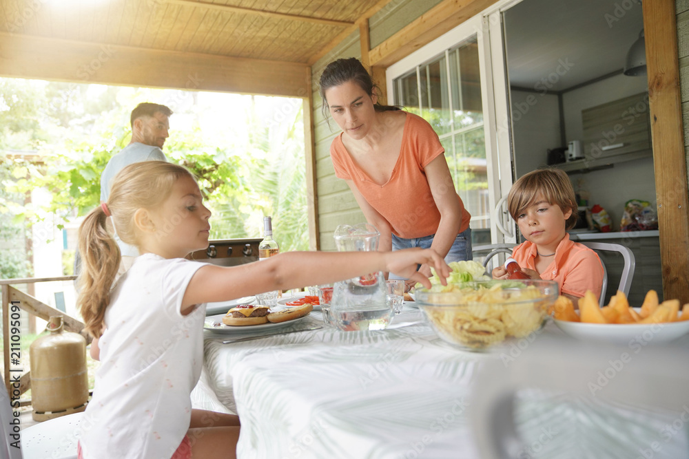 Family on vacation having outdoor lunch
