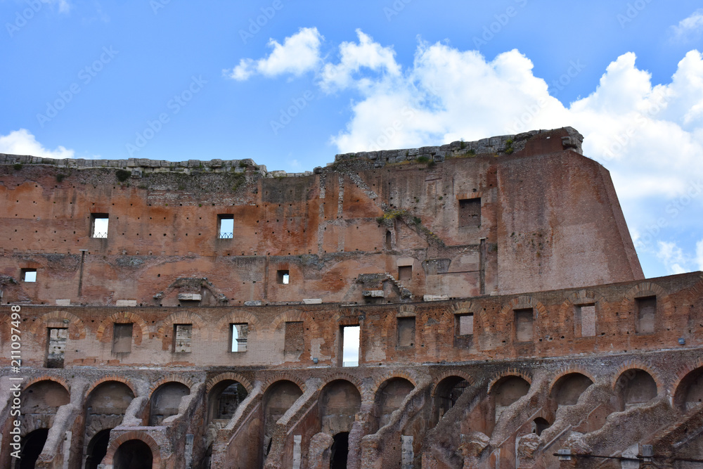 Italy, Rome, Colosseum. View of internal and external architectures. Known as the Flavian Amphitheater, it is the largest amphitheater in the world, located in the city center of Rome.