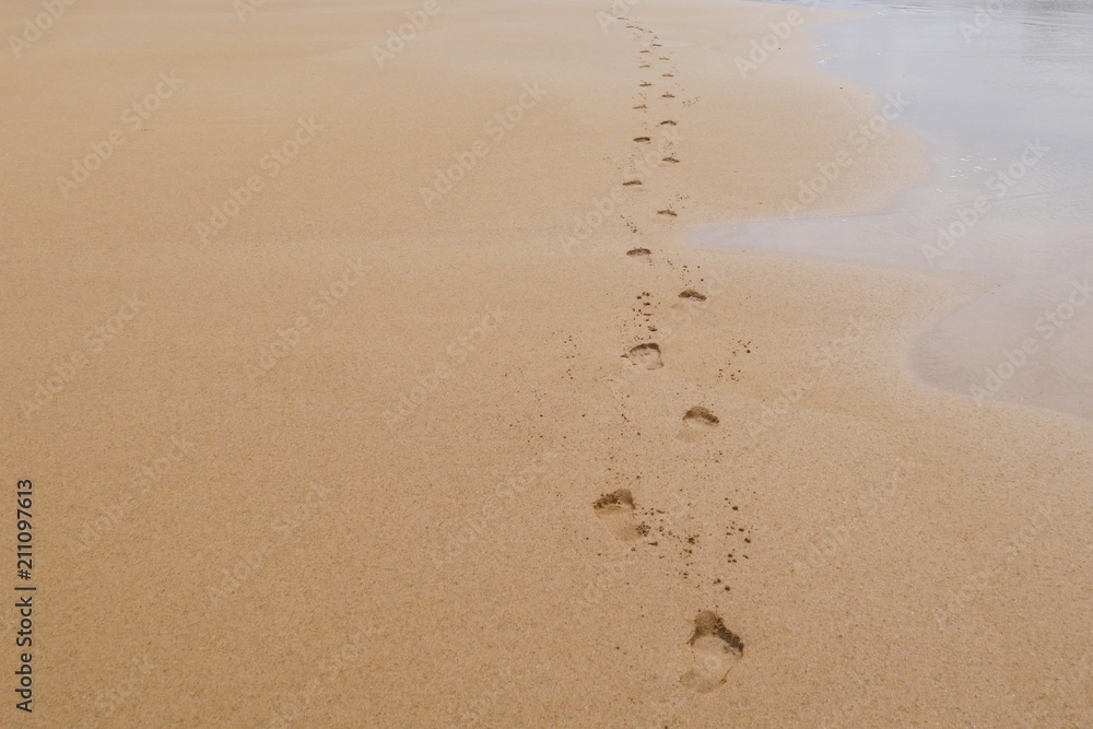 Foot prints in sand, walking barefoot on the beach Foot prints in sand, walking barefoot on the beach