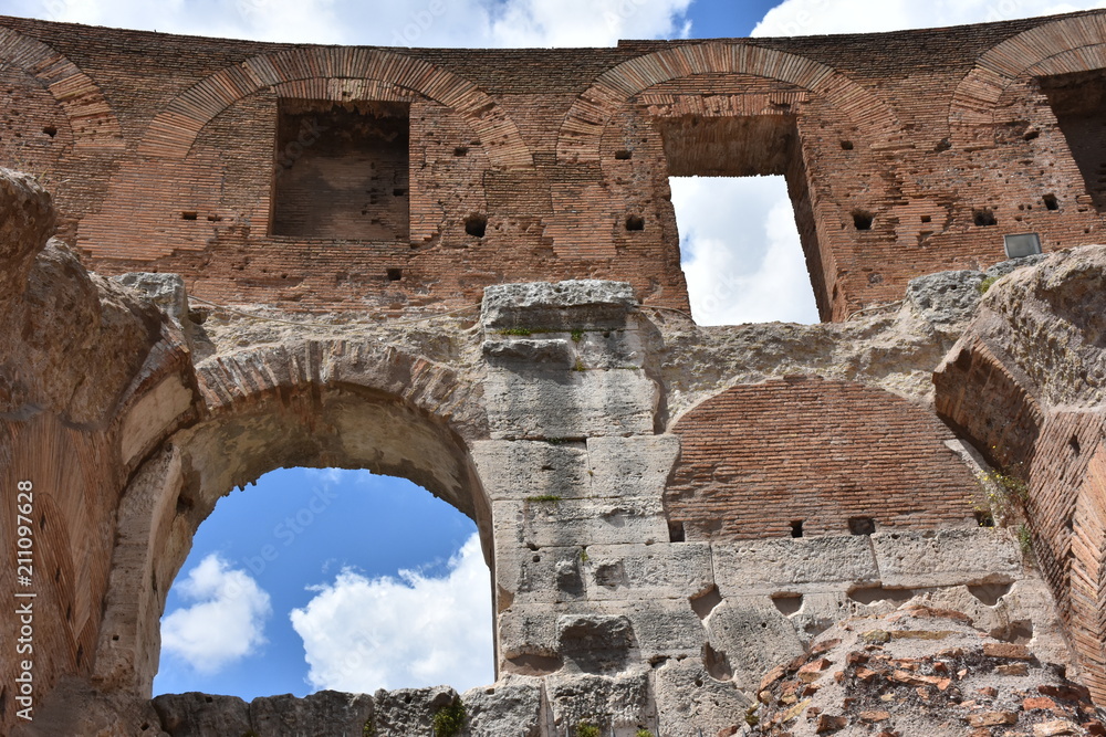 Italy,  Colosseum. View of internal and external architectures. Known as the Flavian Amphitheater, it is the largest amphitheater in the world, located in the city center of Rome.