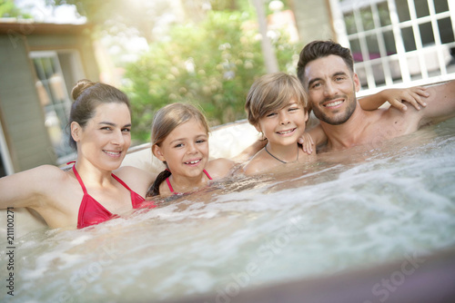Bild auf Leinwand Family of 4 enjoying bath in spa