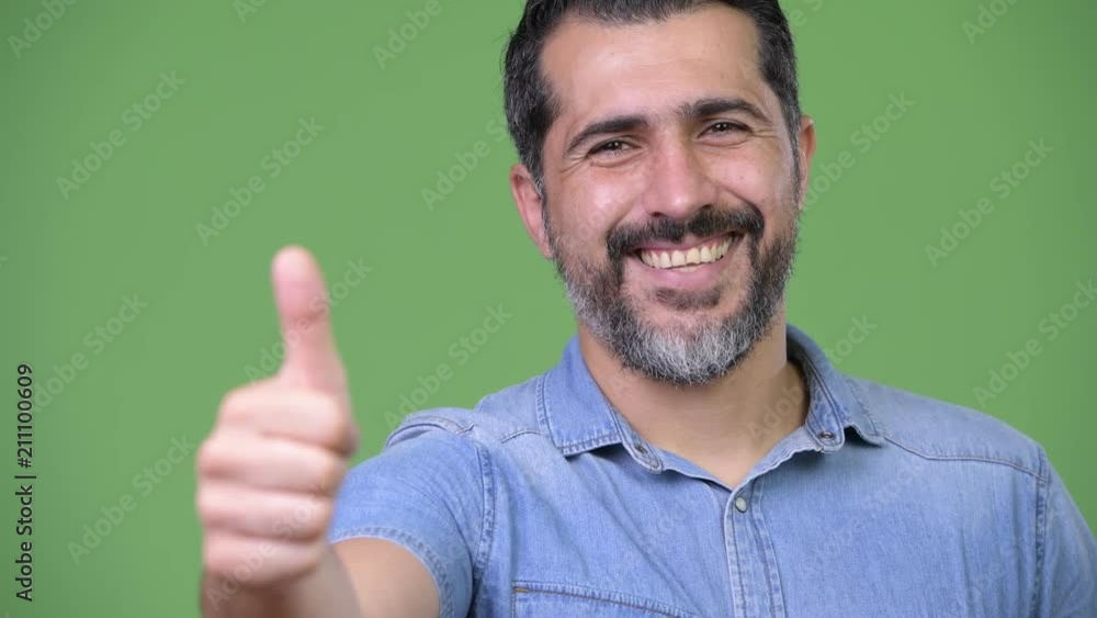 Handsome Persian bearded man giving thumbs up Handsome Persian bearded man giving thumbs up