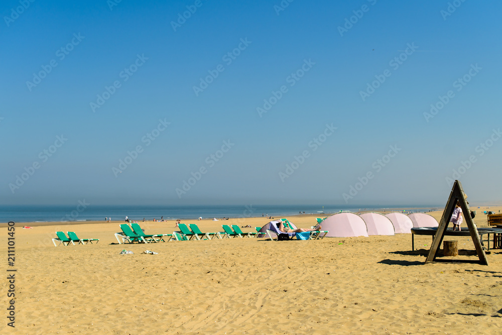 Enjoying life. People relaxing on the sandy beach during vacatio Enjoying life. People relaxing on the sandy beach during vacatio