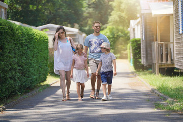 Family walking in camp village during holidays