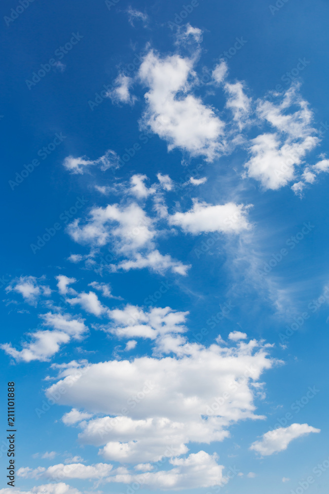 a lot of clouds that go into the distance in perspective, at the bottom are big clouds, and above are small, in a blue sky, a vertical frame a lot of clouds that go into the distance in perspective, at the bottom are big clouds, and above are small, in a blue sky, a vertical frame