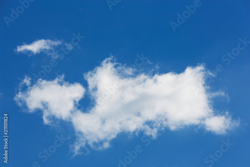 a large white cloud of interesting bizarre shape  on a blue sky  natural background