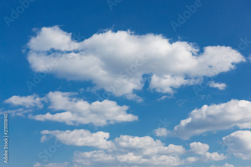 a lot of big clouds, going far into perspective, in the blue sky. natural background © aneduard