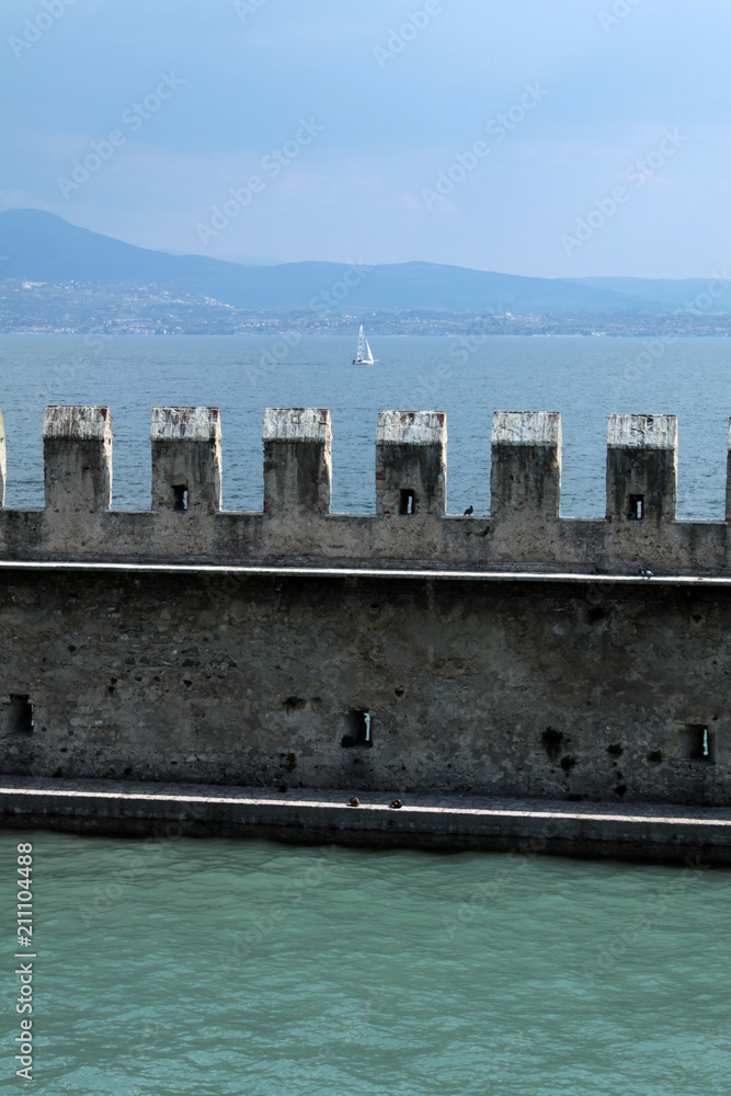external wall of Sirmione Castle with Garda lake landscape