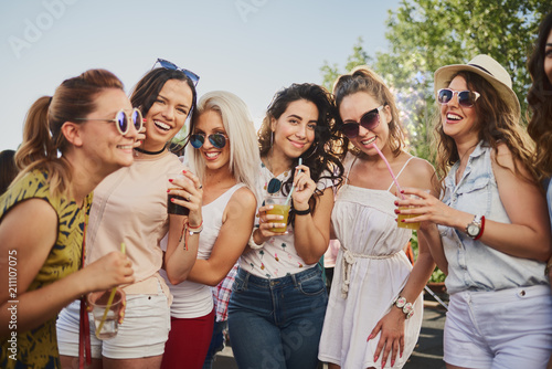 Group of female friends posing and having a good time at the outdoor party/music festival  © chika_milan