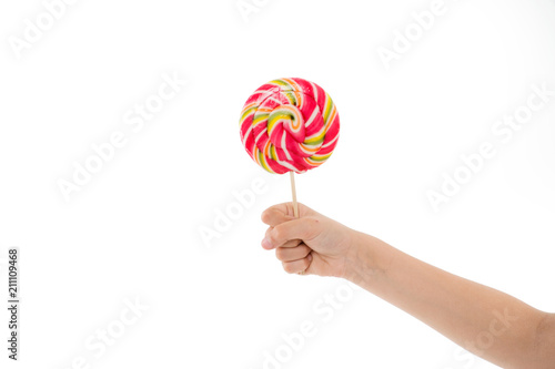 Understanding role sugar young diets. Hand of kid child holds colorful lollipop isolated white background. Children have innate ability adjust diet energy intake. Sweet treats can have place in diet