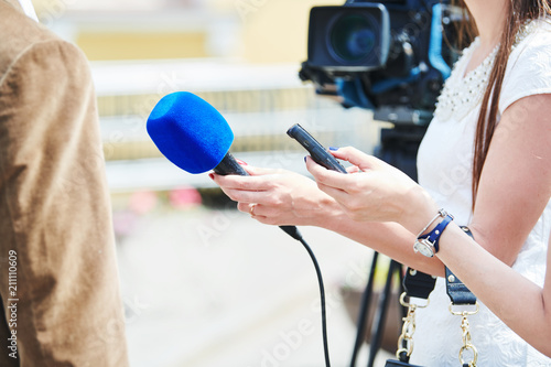 News comment. reporter with microphone making interview