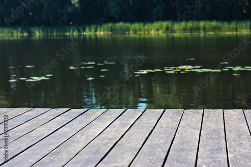 Pier, river and forest. View of the river and pier. Beautiful summer green view, landscape. Summer background.