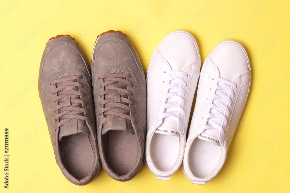 male sneakers and sneakers on a colored background top view. men's footwear. minimalism male sneakers and sneakers on a colored background top view. men's footwear. minimalism