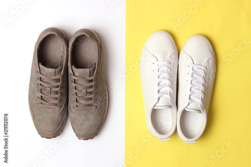 male sneakers and sneakers on a colored background top view. men's footwear. minimalism