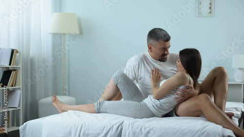 Woman throwing away condom before intimacy, desire to have child, healthy family