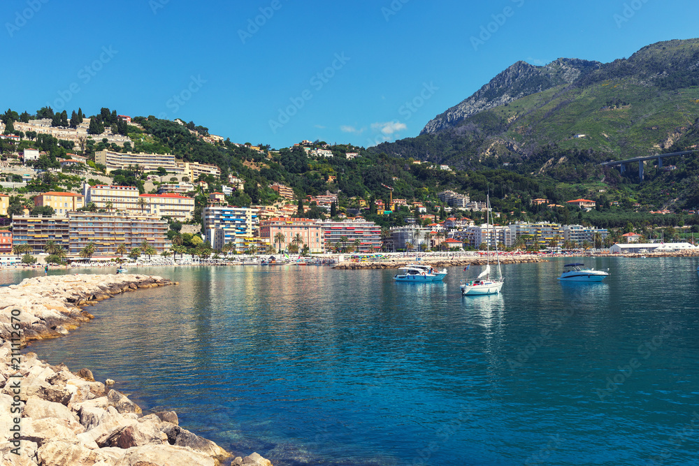 View of Menton city harbour from french Riviera in a beautiful summer day, France. Sea with mountains that make a beautiful contrast.
