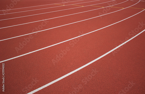 sport concept of red running track road with white lane marking background texture and empty space for copy or text