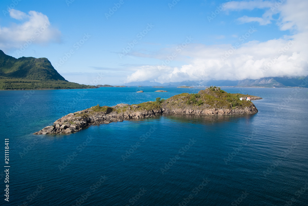 Masterpieces of nature. Island stony surrounded sea water in Norway. Best nature places to visit in Norway. Seascape with island on sunny day. Serenity and idyllic. Island stony cliffs coast