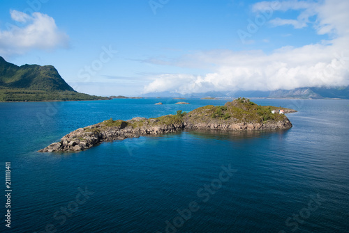 Masterpieces of nature. Island stony surrounded sea water in Norway. Best nature places to visit in Norway. Seascape with island on sunny day. Serenity and idyllic. Island stony cliffs coast