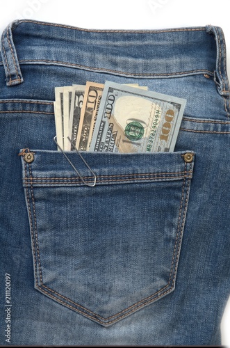 US dollars in the back pocket of blue jeans