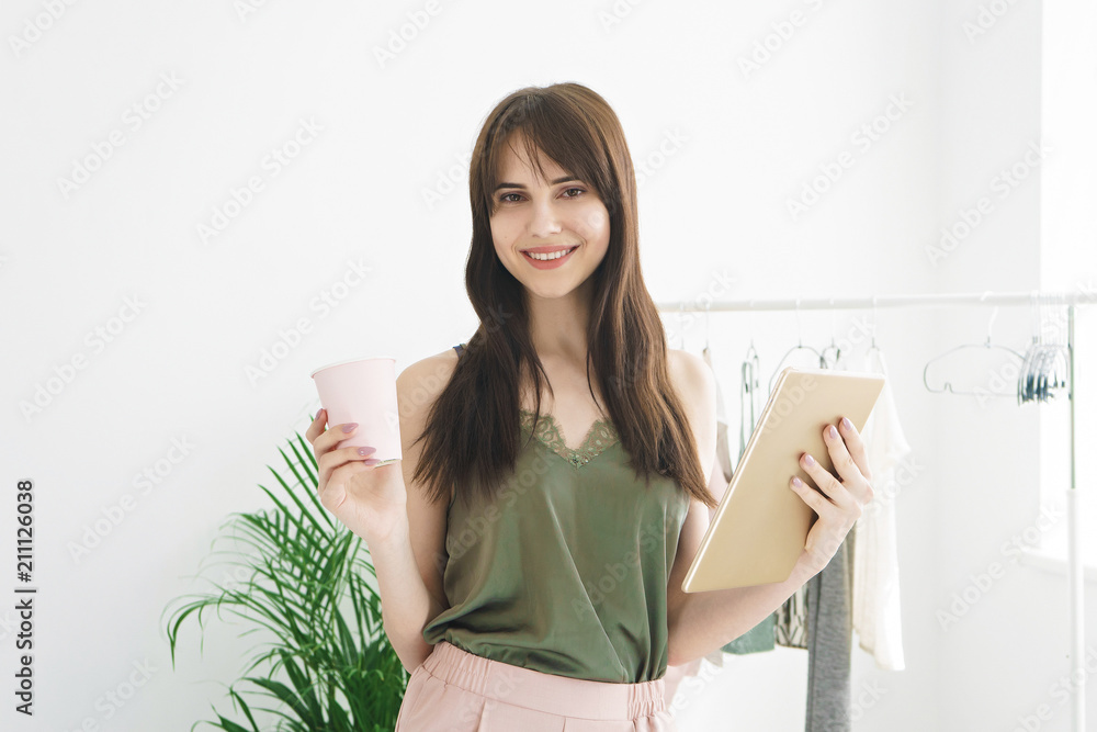 beautiful young woman holding tablet and coffee and smiling beautiful young woman holding tablet and coffee and smiling
