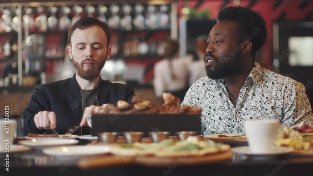 men's company in the restaurant. two friends at a friendly dinner