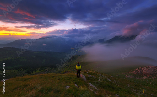 Photography Climber among the foggy mountains