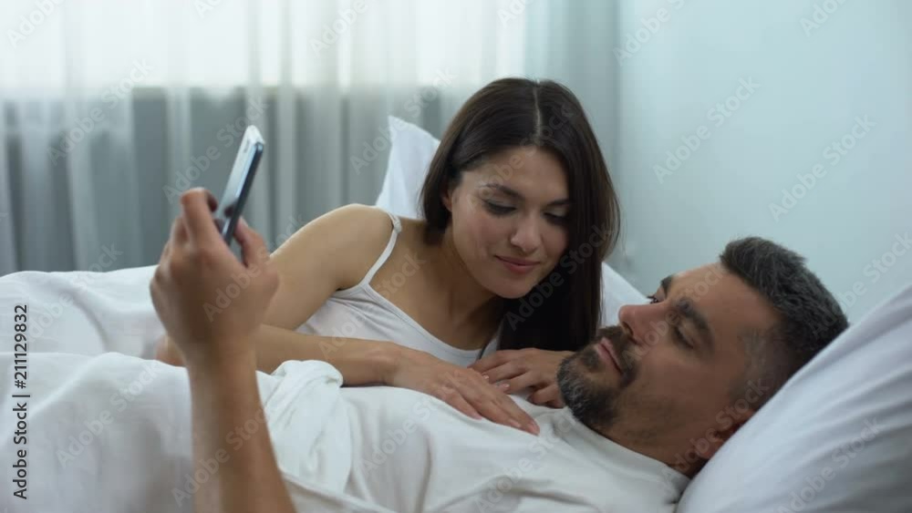 Man addicted to mobile games, ignoring wife flirting in bed, relationship crisis Man addicted to mobile games, ignoring wife flirting in bed, relationship crisis