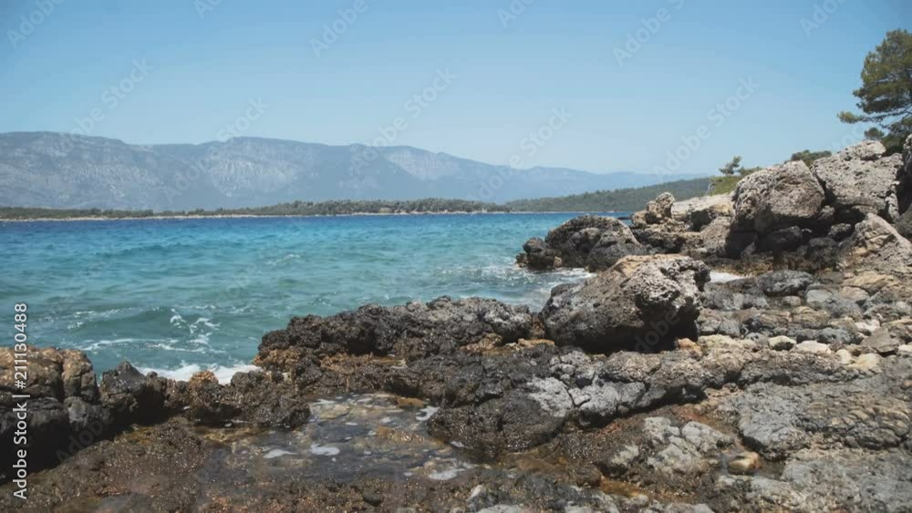 Rocky beach and azure blue waters of the Mediterranean sea. Rocky beach and azure blue waters of the Mediterranean sea.