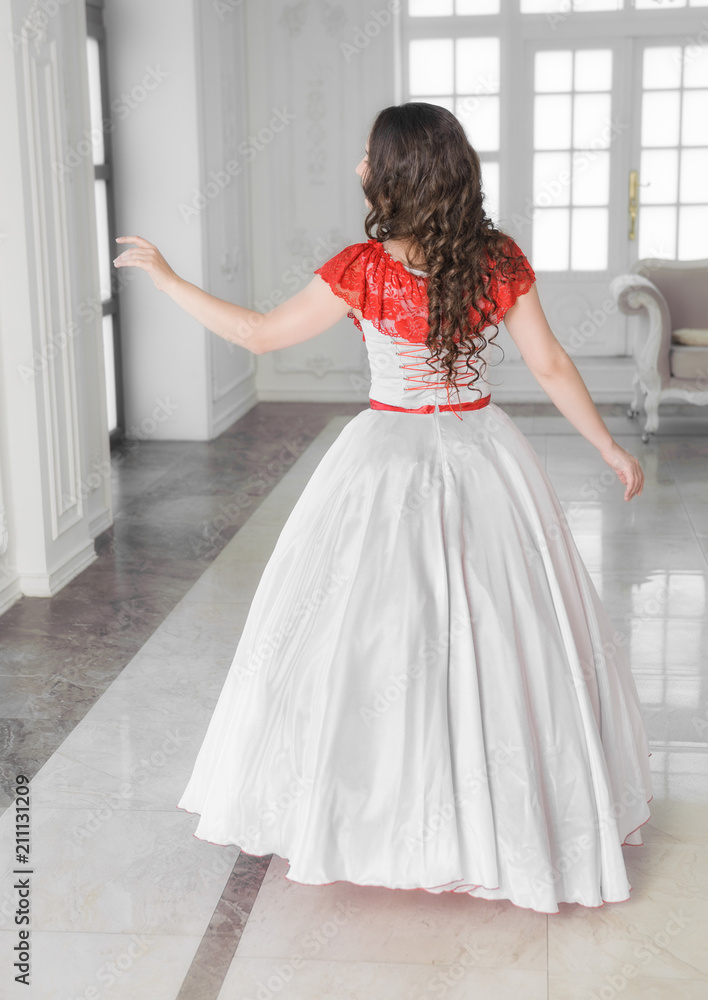 Beautiful woman in medieval dress with crinoline. Back pose Beautiful woman in medieval dress with crinoline. Back pose