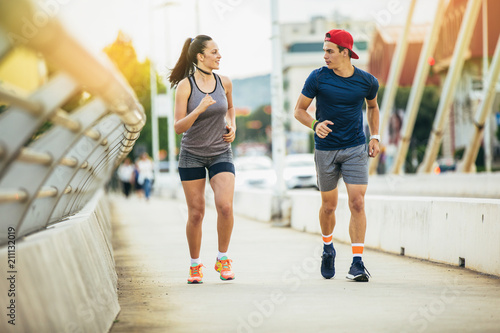 fitness, sport, people and lifestyle concept - man and woman exercising outdoors