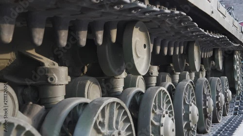 Soviet battle tank on a pedestal in a park with military equipment