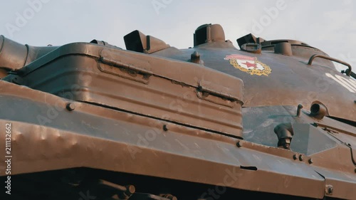 Soviet battle tank on a pedestal in a park with military equipment