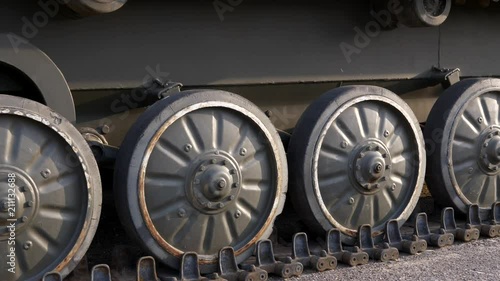 Soviet battle tank on a pedestal in a park with military equipment