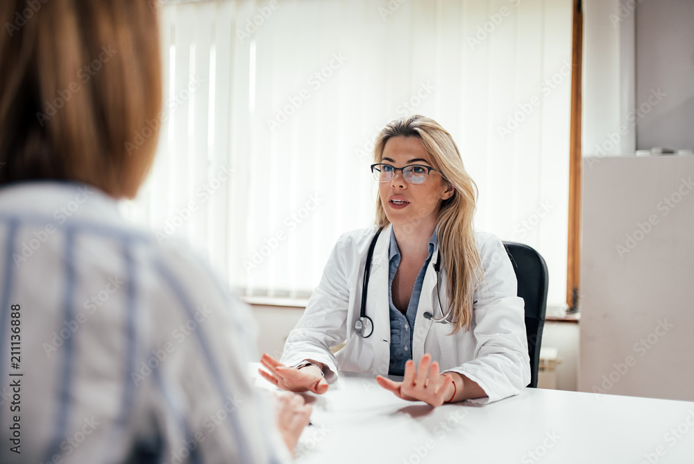 Female general practicioner talking to a patient.
