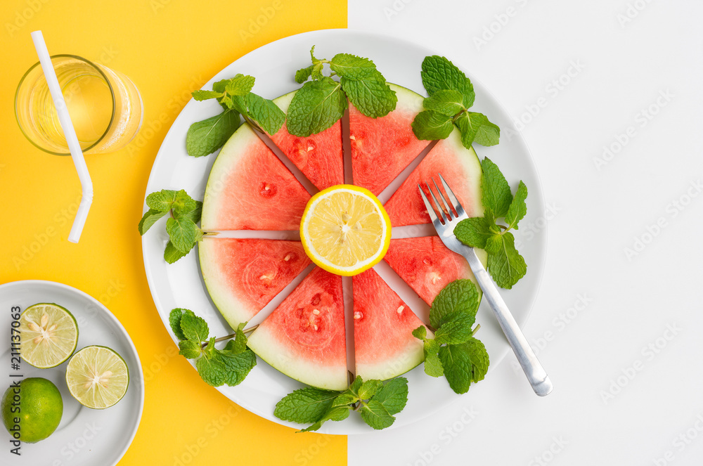 Sliced watermelon on plate with mint and lemon, ready to eat. Sliced watermelon on plate with mint and lemon, ready to eat.
