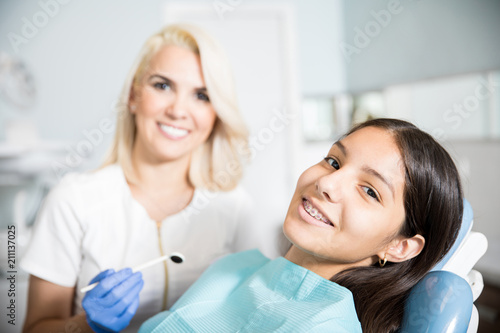Cute happy patient in an orthodontic clinic photo
