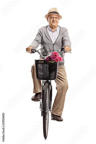 Mature man riding a bicycle towards the camera