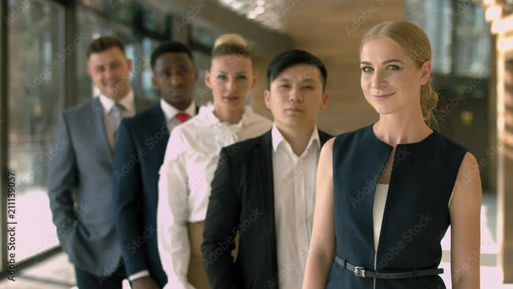 Group of multiracial business team standing in a row in the lobby Group of multiracial business team standing in a row in the lobby