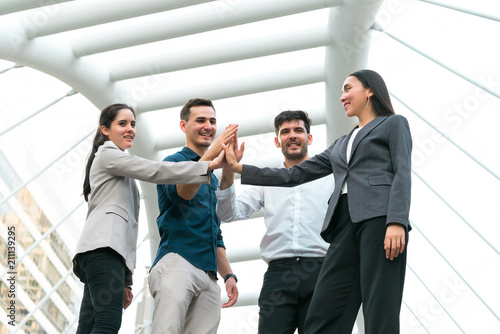 Business people team meeting with present hands together at outdoors. Concept of teamwork, team success, people creative, business people and power of group. photo