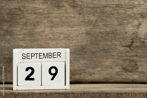 Fototapeta Naklejka Na Ścianę i Meble -  White block calendar present date 29 and month September on wood background