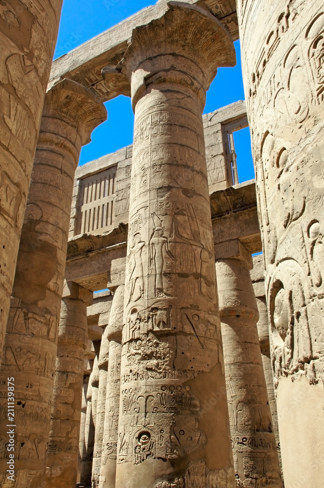 Relief and hieroglyphs on the columns of a large hypostyle temple in Karnak, Egypt Relief and hieroglyphs on the columns of a large hypostyle temple in Karnak, Egypt