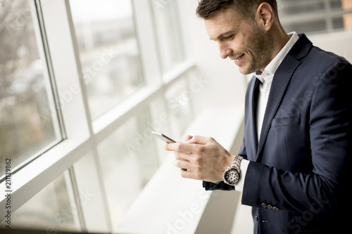Handsome businessman using ...