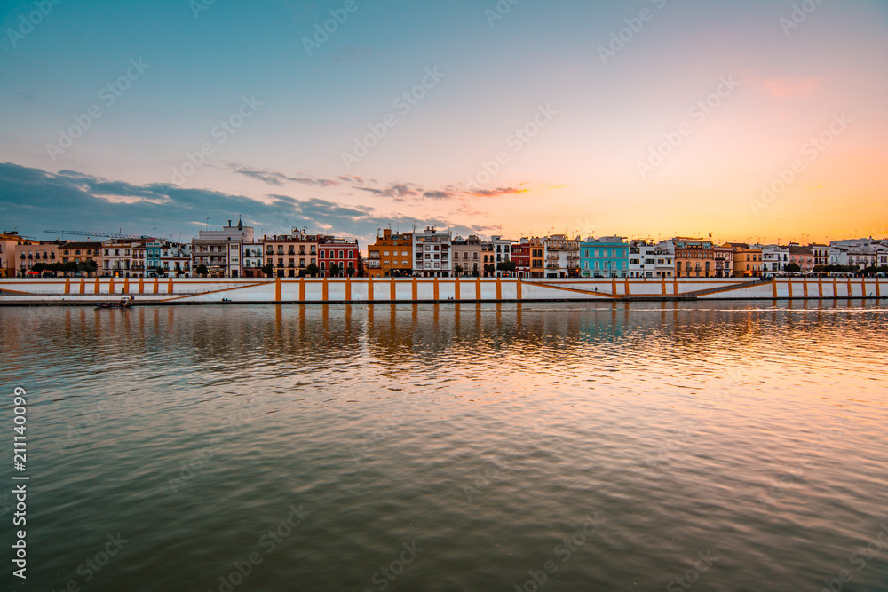 Teal and orange view of Guadalquivir river and Triana district in Sevilla, Andalusia, Spain