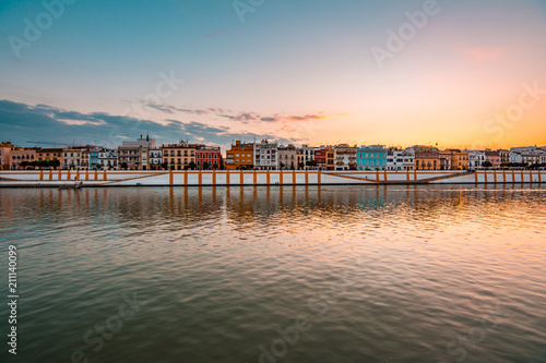 Teal and orange view of Guadalquivir river and Triana district in Sevilla, Andalusia, Spain photo