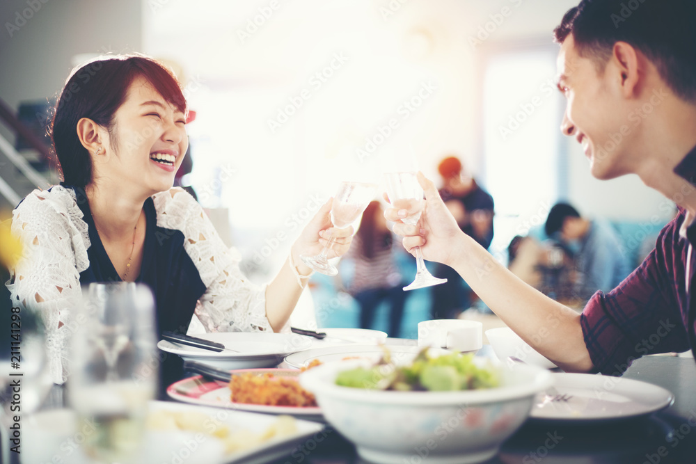 Asian young couple enjoying a romantic dinner evening drinks while sitting at the dinning table on the kitchen together,soft focus Asian young couple enjoying a romantic dinner evening drinks while sitting at the dinning table on the kitchen together,soft focus