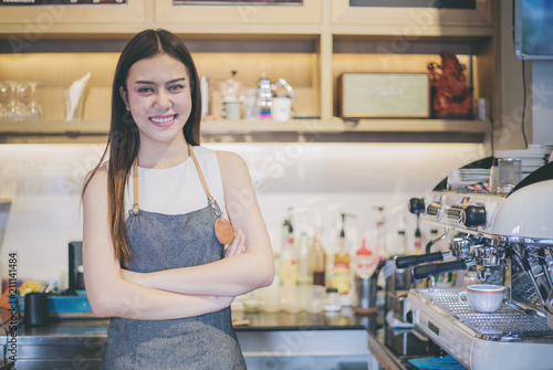 Asian women Barista smiling and using coffee machine in coffee shop counter - Working woman small business owner food and drink cafe concept