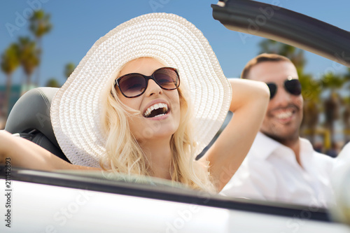 road trip, travel and people concept - happy couple driving in convertible car over venice beach background in california © Syda Productions